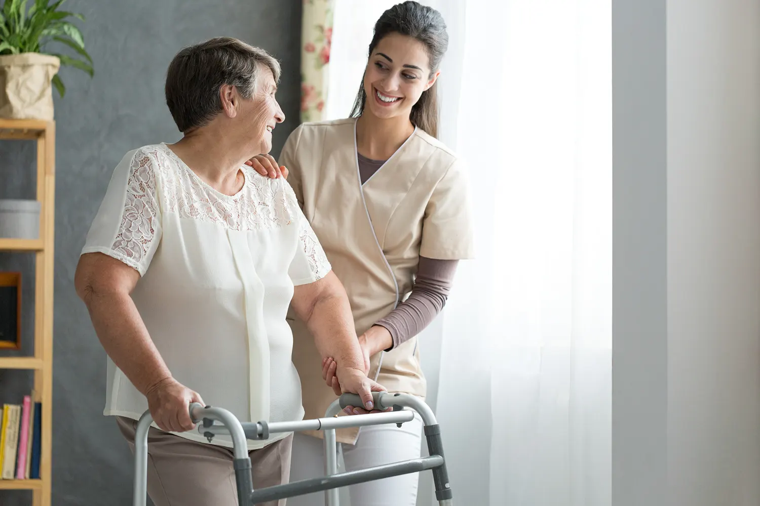 Nurse helping senior lady to walk - Promotion Independence Envision Home Health