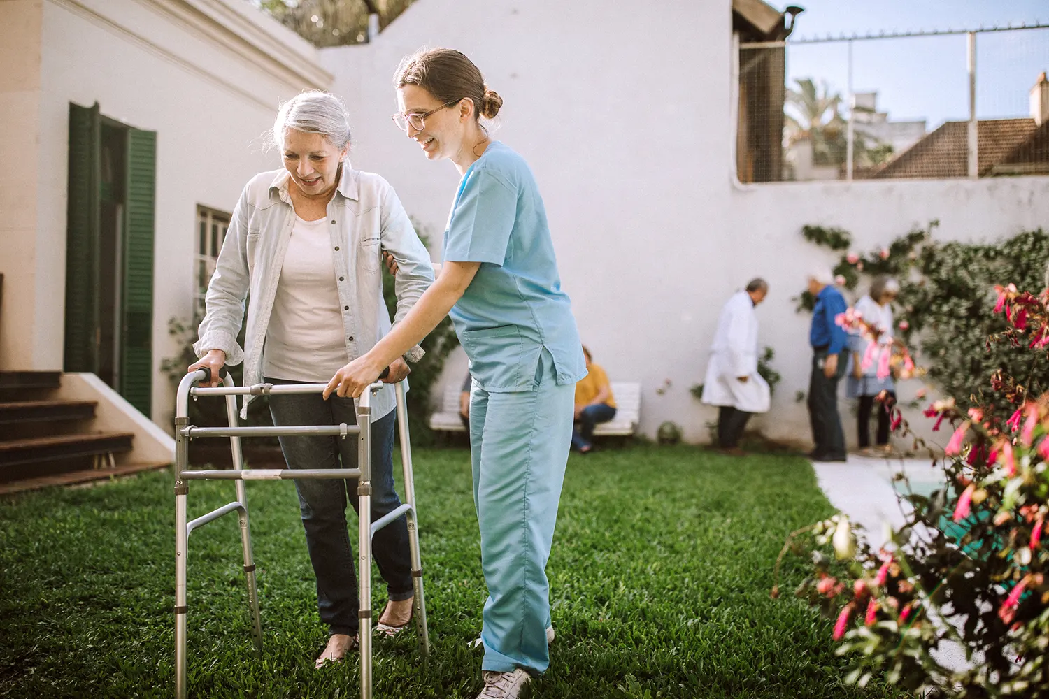 Nurse helping senior woman with mobility - Envision Home Health